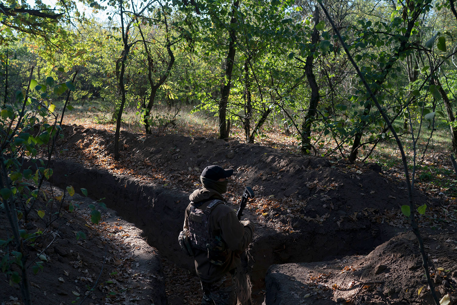 En ukrainsk soldat undersøker en russisk skyttergrav i utkanten av Kherson.